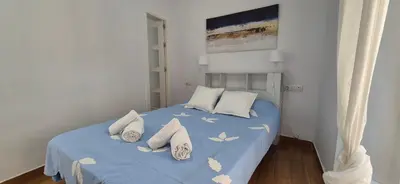 a bedroom with a blue bed with butterflies on it at Cobos by Gades Gestión in Cádiz