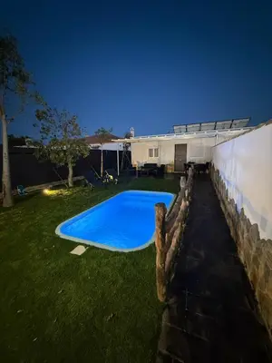 a swimming pool in the yard of a house at casitas de las palmeras in Cádiz