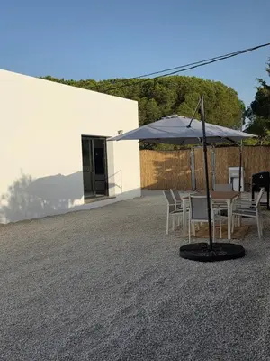 a white building with lights on the side of it at Alojamiento Rural Cortijo Rosario in Conil de la Frontera