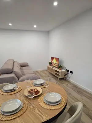 a living room with a table and a couch at Alojamiento Rural Cortijo Rosario in Conil de la Frontera