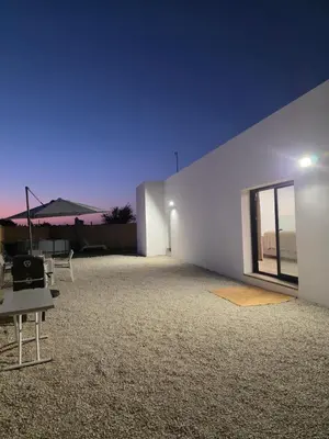 a room with a white wall and a table at Alojamiento Rural Cortijo Rosario in Conil de la Frontera
