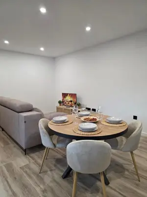 a dining room with a table and chairs and a couch at Alojamiento Rural Cortijo Rosario in Conil de la Frontera