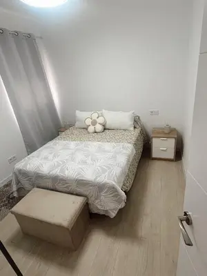 a bedroom with a bed with a teddy bear on it at Apartamento patio Andaluz in Rota