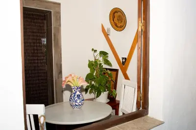 a table with a blue and white vase on it at Casa Rural con Jacuzzi en Conil de la Frontera in Cádiz