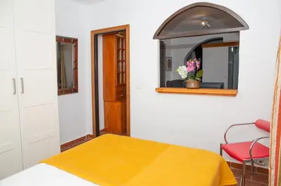 a living room with two chairs and a tv at Casa Rural con Jacuzzi en Conil de la Frontera in Cádiz