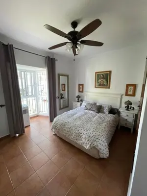 a bedroom with a bed and a ceiling fan at Villa Clara Chiclana in Chiclana de la Frontera