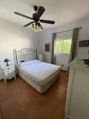 a bedroom with a bed and a ceiling fan at Villa Clara Chiclana in Chiclana de la Frontera