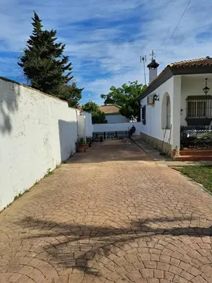a brick road in front of a white building at Villa Clara Chiclana in Chiclana de la Frontera