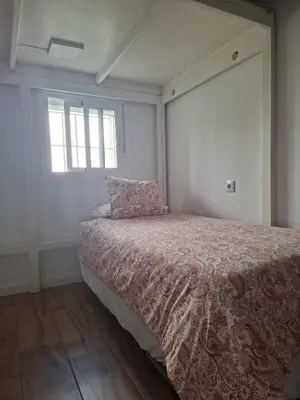 a bedroom with a bed and a window at La Casita de las Piletas in Sanlúcar de Barrameda