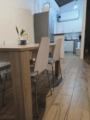 a kitchen with a wooden table and chairs at La Casita de las Piletas in Sanlúcar de Barrameda