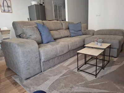 a living room with a couch and a table at La Casita de las Piletas in Sanlúcar de Barrameda