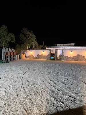 a dirt road in front of a building at night at Casita Las Palmeras 3 in Cádiz