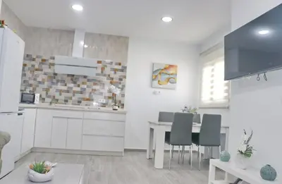 a kitchen and dining room with a table and chairs at Casa el rincón de la Rosa in Conil de la Frontera