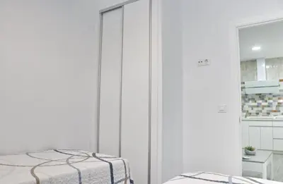 a white room with a bed and a closet at Casa el rincón de la Rosa in Conil de la Frontera