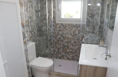 a bathroom with a toilet and a sink and a window at Casa el rincon de la Rosa II in Conil de la Frontera