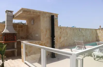 a view of a house with a patio and a swimming pool at Casa el rincon de la Rosa II in Conil de la Frontera