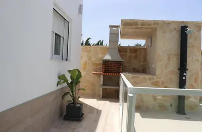 a kitchen with a stove in the middle of a building at Casa el rincon de la Rosa II in Conil de la Frontera
