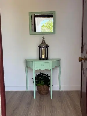 a green table with a lantern on it with a plant at Azul Sancti Petri in Chiclana de la Frontera