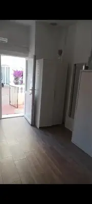 a room with two refrigerators and an open door at Apartamento Dali in El Puerto de Santa María