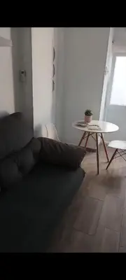 a living room with a couch and a table at Apartamento Dali in El Puerto de Santa María