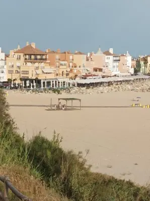a view of a beach with a gazebo at Apartamento Dali in El Puerto de Santa María