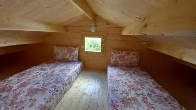a bedroom with two beds in a log cabin at Cosy Cabin in Cádiz in Chiclana de la Frontera