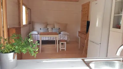 a small kitchen with a table in a tiny house at Cosy Cabin in Cádiz in Chiclana de la Frontera