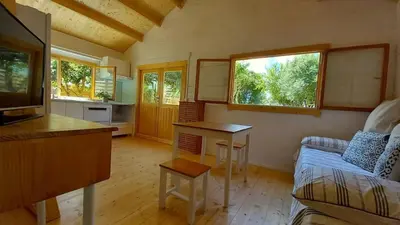 a living room with a couch and a table at Cosy Cabin in Cádiz in Chiclana de la Frontera