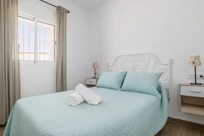 a bedroom with a bed with two towels on it at Casa Sol in Conil de la Frontera