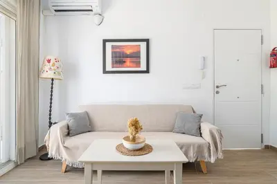 a living room with a couch and a table at Casa Sol in Conil de la Frontera