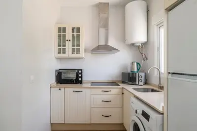 a kitchen with a sink and a microwave at Casa Sol in Conil de la Frontera