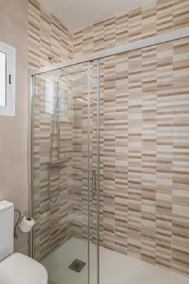 a shower with a glass door in a bathroom at Casa Sol in Conil de la Frontera