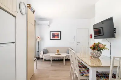 a living room with a table and a couch at Casa Sol in Conil de la Frontera