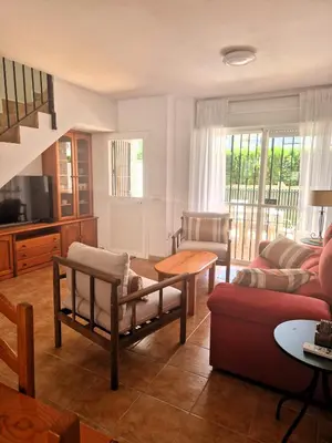 a living room with a couch and a table at Primera Línea de Playa Casa adosada La Balconera in Chiclana de la Frontera