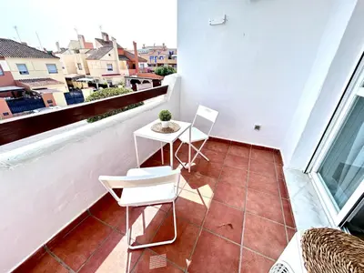 a balcony with two chairs and a table on it at Apartamento Empul Rota Príncipe in Rota