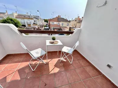 a patio with a table and chairs on a balcony at Apartamento Empul Rota Príncipe in Rota