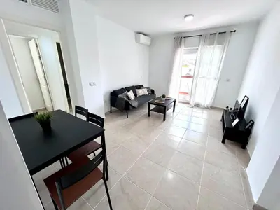 a living room with a table and a couch at Apartamento Empul Rota Príncipe in Rota