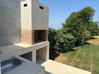 a kitchen with a fireplace on top of a house at Mirador las Cumbres Conil - Piscina Jardín XL in Conil de la Frontera