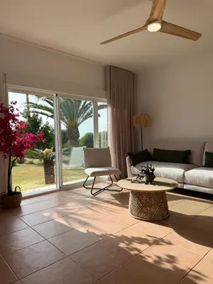 a living room with a couch and a table at Mirador las Cumbres Conil - Piscina Jardín XL in Conil de la Frontera