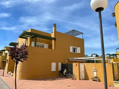 a yellow building with a street light in front of it at Villa Costa Ballena in Rota