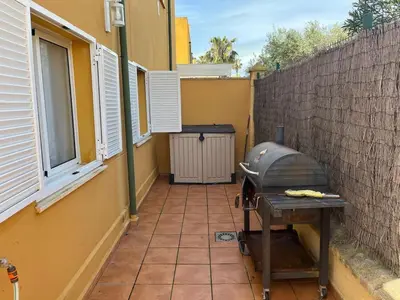 a patio with a grill on the side of a building at Villa Costa Ballena in Rota