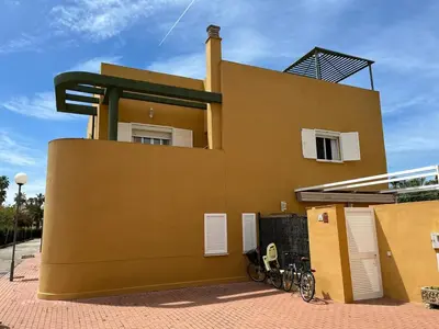a building with a bike parked in front of it at Villa Costa Ballena in Rota