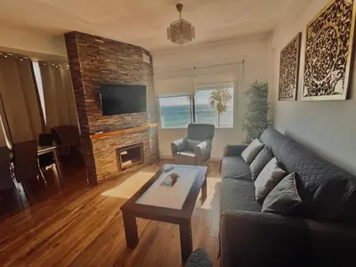 a living room with a couch and a fireplace at Apartamento en Fuentebravia in El Puerto de Santa María
