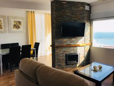 a living room with a couch and a fireplace at Apartamento en Fuentebravia in El Puerto de Santa María