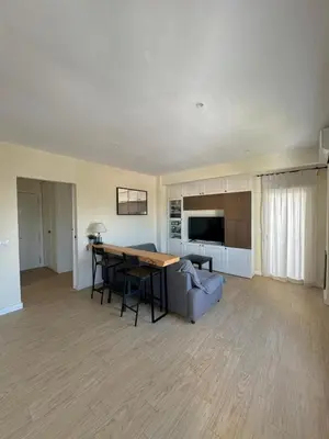 a living room with a table and a couch at Apartamento Valdelagrana vistas al Mar in El Puerto de Santa María