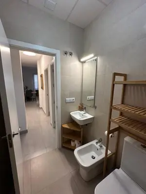 a bathroom with a sink and a toilet and a mirror at La Caleta in Cádiz