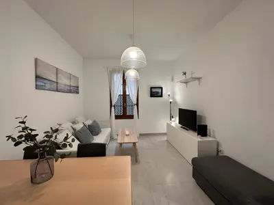 a living room with a couch and a tv at La Caleta in Cádiz