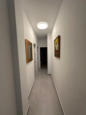 a hallway with two paintings on the walls at La Caleta in Cádiz