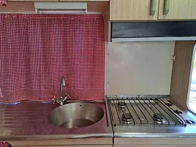 a kitchen with a sink and a counter with a stove at Villa Paquita in Vallejas
