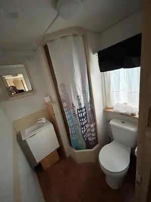 a small bathroom with a toilet and a window at Villa Paquita in Vallejas
